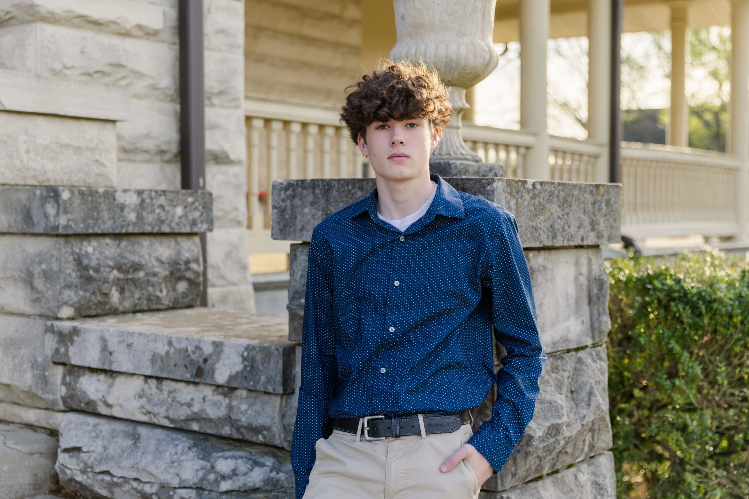Senior high boy posing for his senior portraits