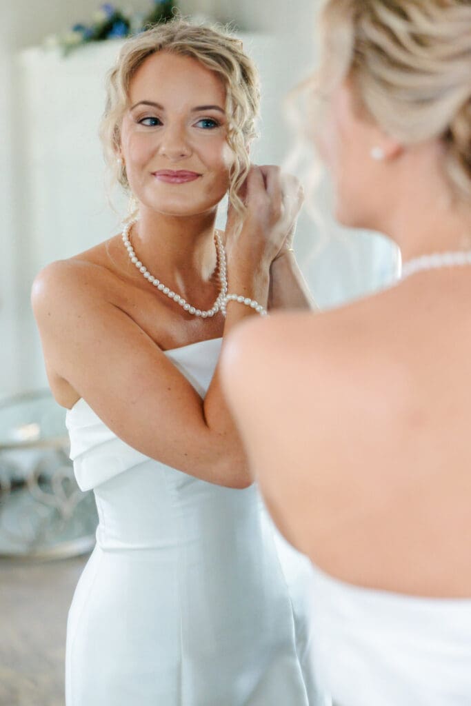 Claire putting on her earrings.