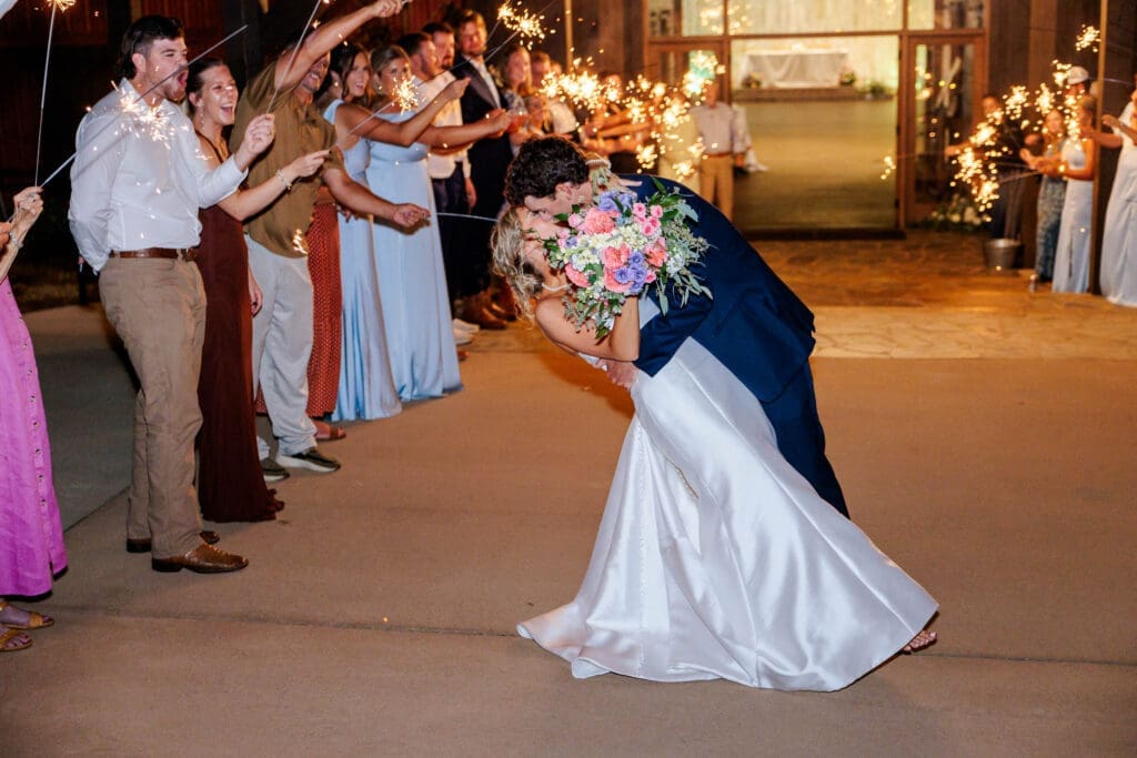 Bride and groom sparkler exit with a perfect dip.