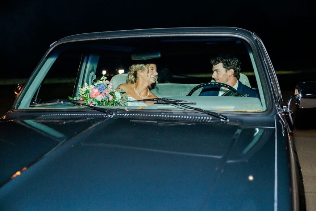 Bride and groom leaving the wedding in a vintage truck.