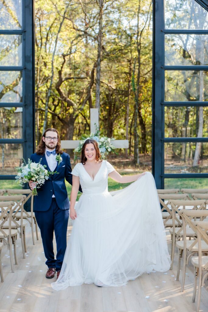 Bride and groom posing for just married photos at Jubilee Woods wedding venue