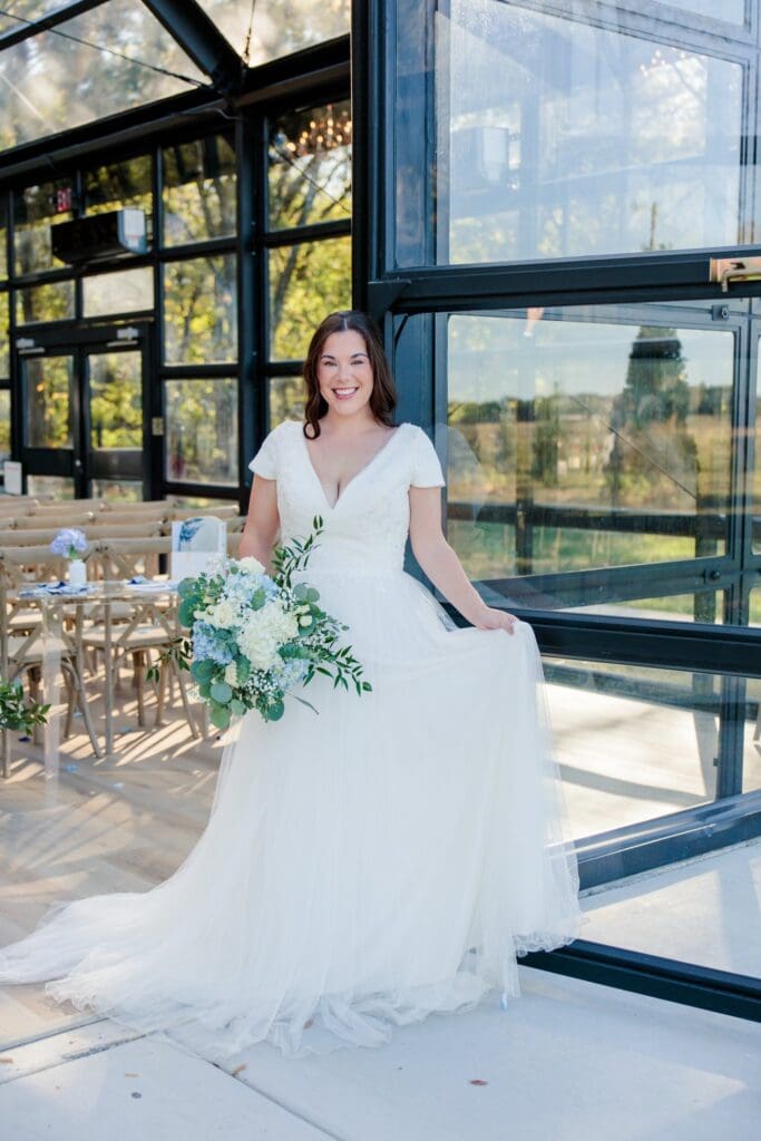 Bridal portraits at glass chapel at Jubilee Woods wedding venue