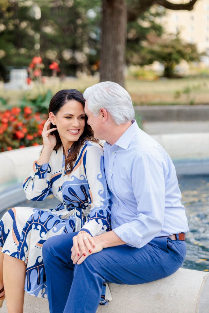 Engaged couple sharing a kiss beside the fountain in Nashville