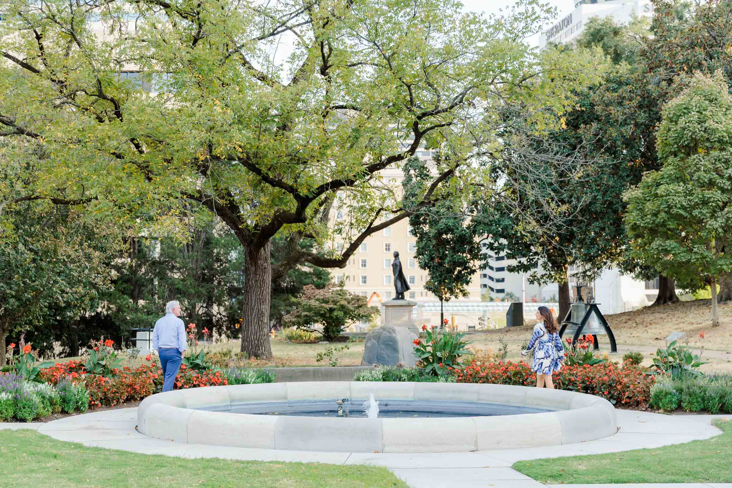 An engaged couple walking toward one another in a garden in Nashville