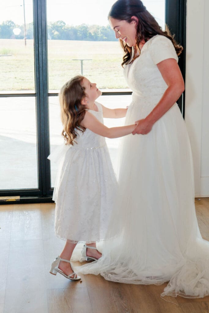 Bride dancing with her daughter during the wedding celebration
