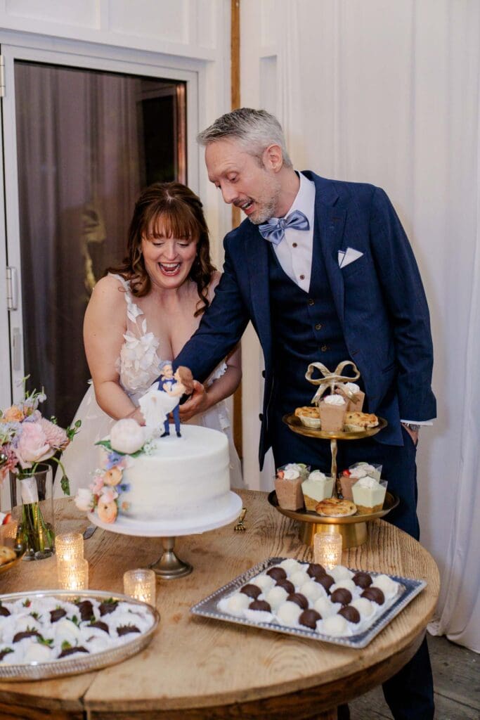 Bride and groom cut the cake at reception at Iriswoods in Mt. Juliet, TN