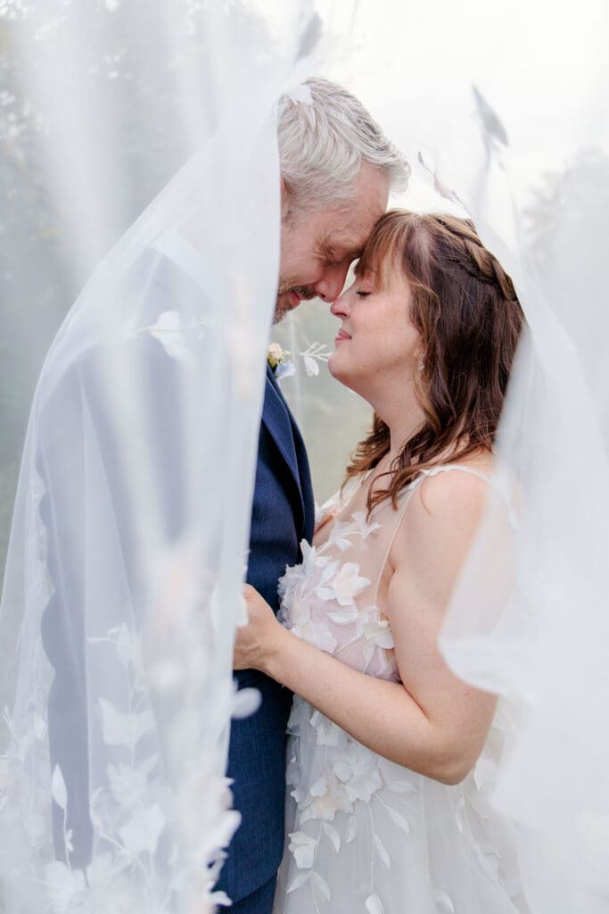 Bride and groom under veil at Iriswoods wedding venue near Nashville, TN