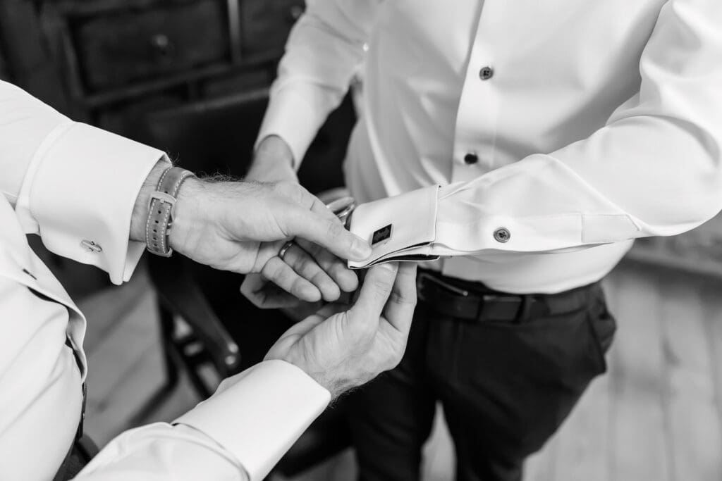 Best man helping groom get dressed at Iriswoods in Mt. Juliet, TN