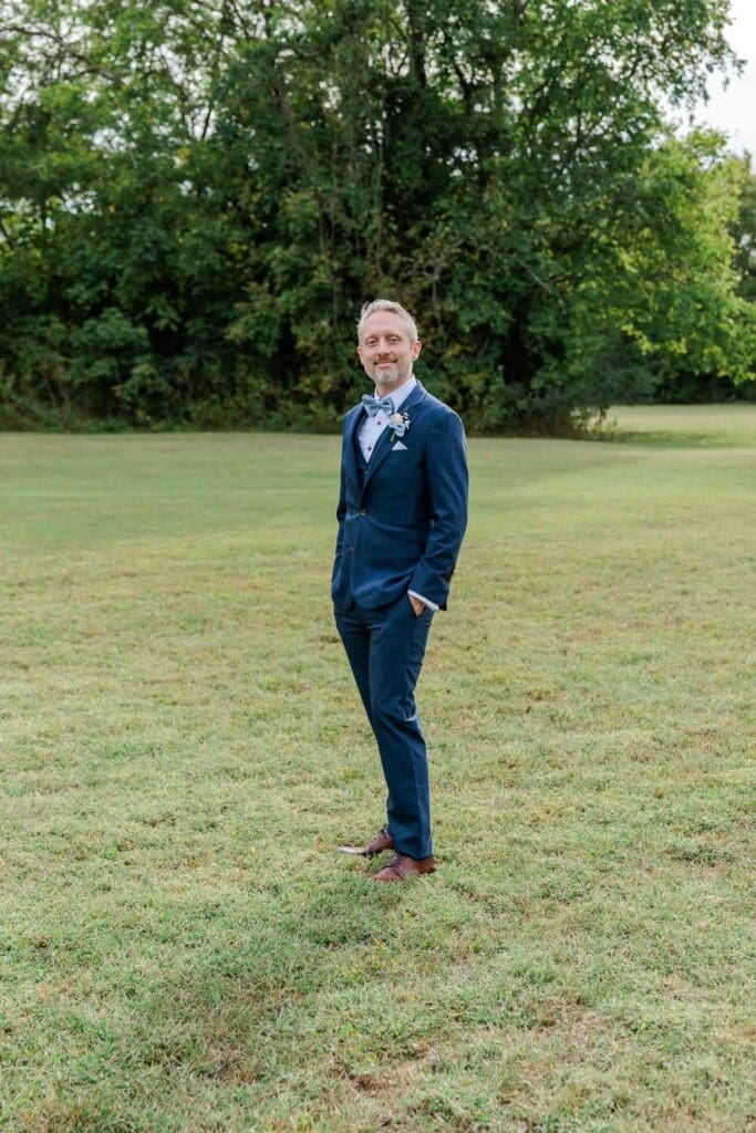 Groom posing outside at Iriswoods wedding and events venue