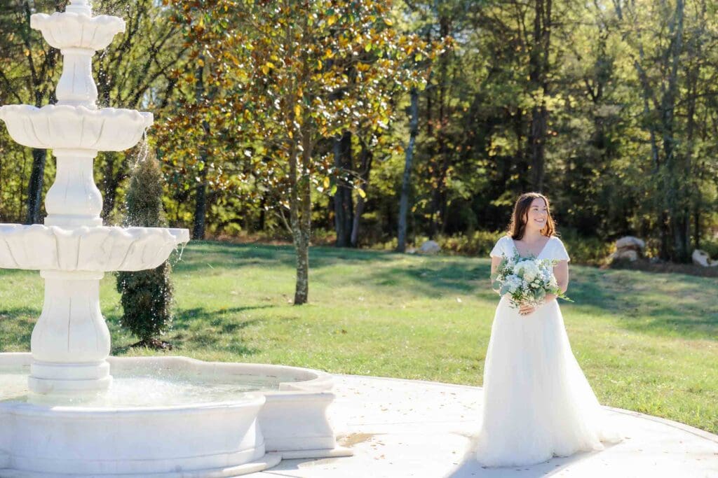 Bride posing near the water fountain at Jubilee Woods