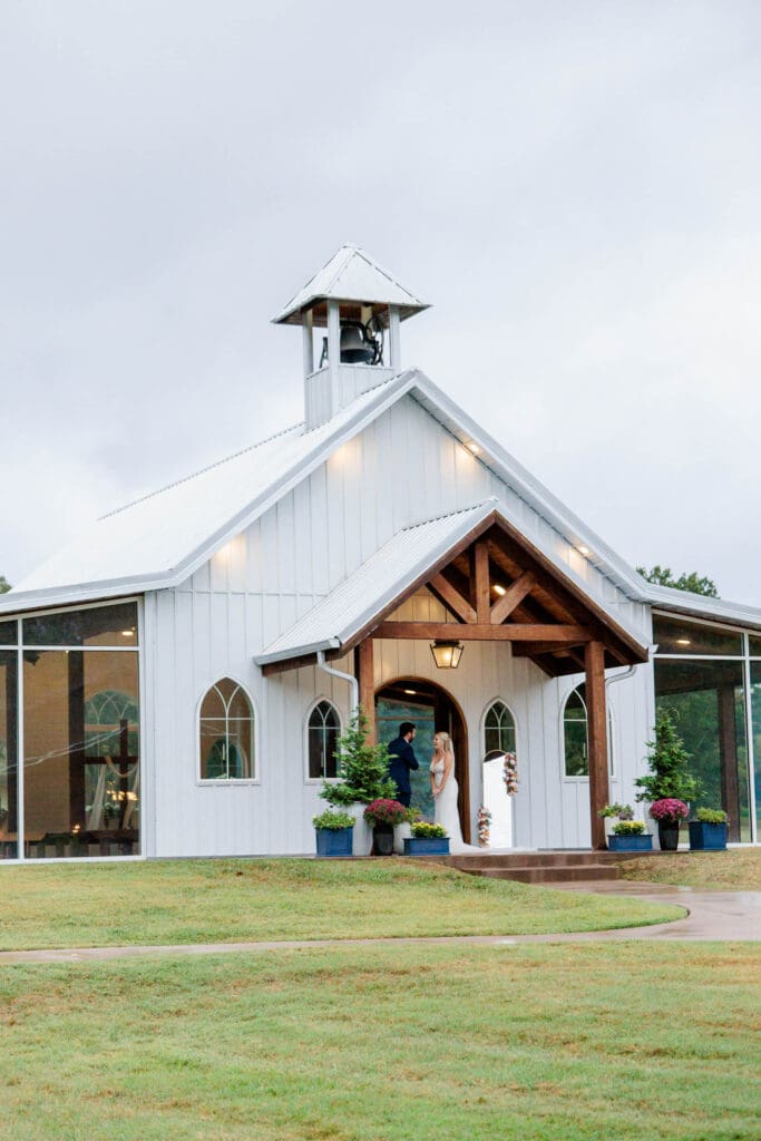First look with groom on the porch of a wedding chapel in Springfield, Tennessee.