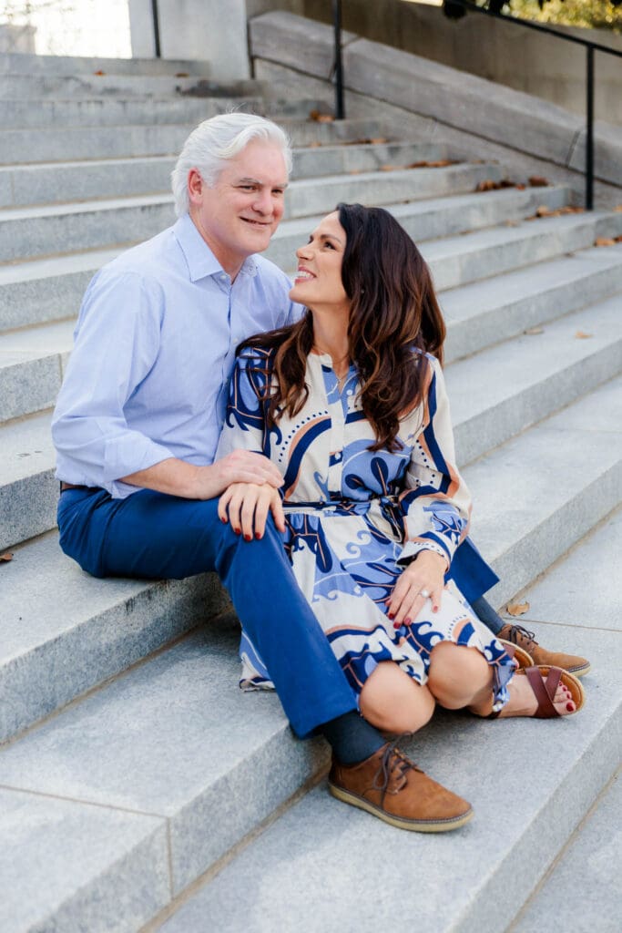 Engaged couple sitting together on the steps in Downtown Nashville