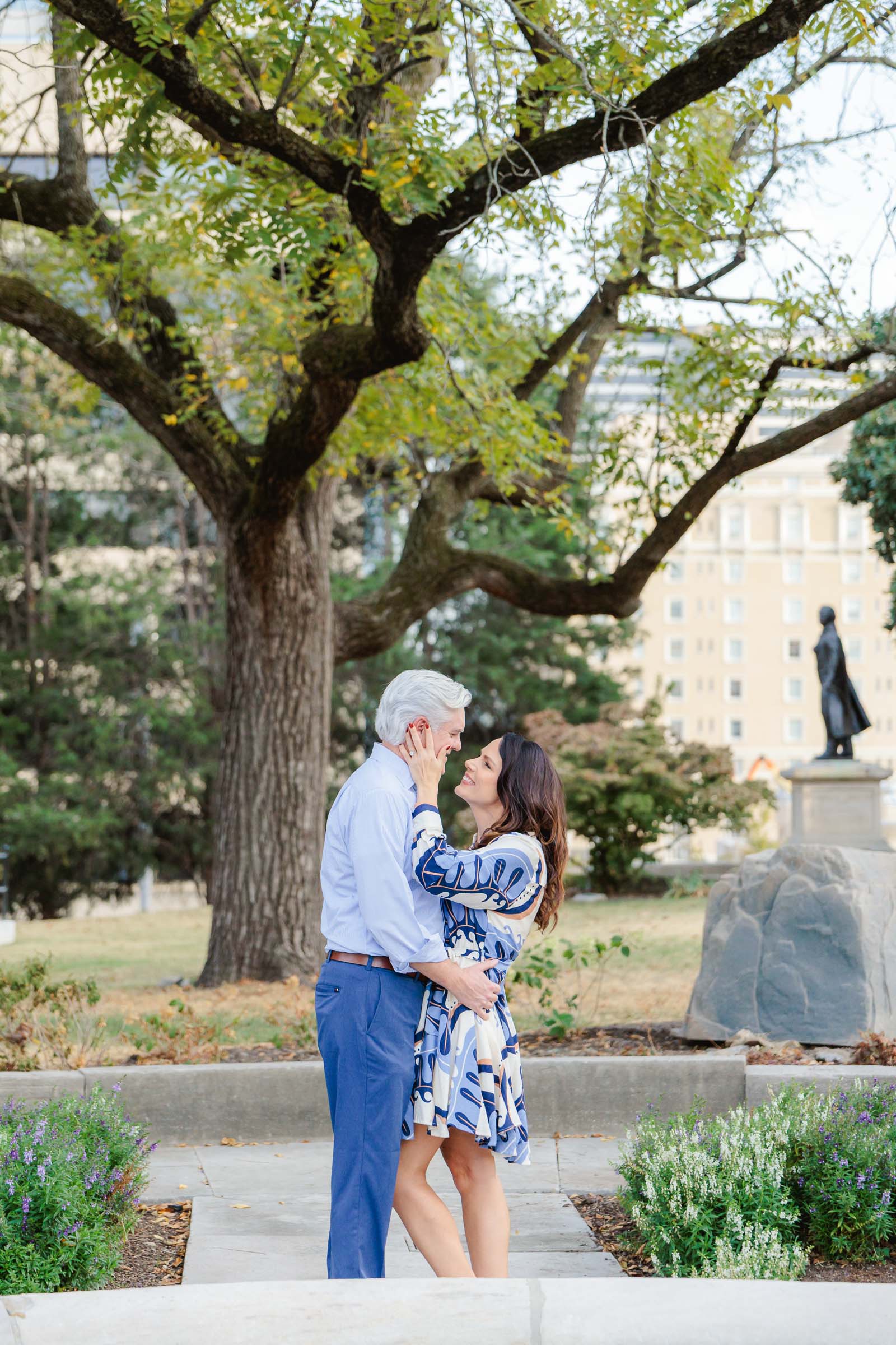 An engaged couple posting for their engagement portraits in downtown Nashville, TN