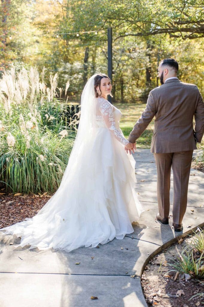 Bride and groom strolling along walkway at Firefly Lane