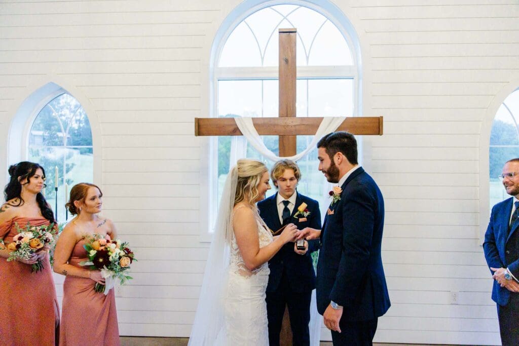 Bridegroom exchange rings in the chapel