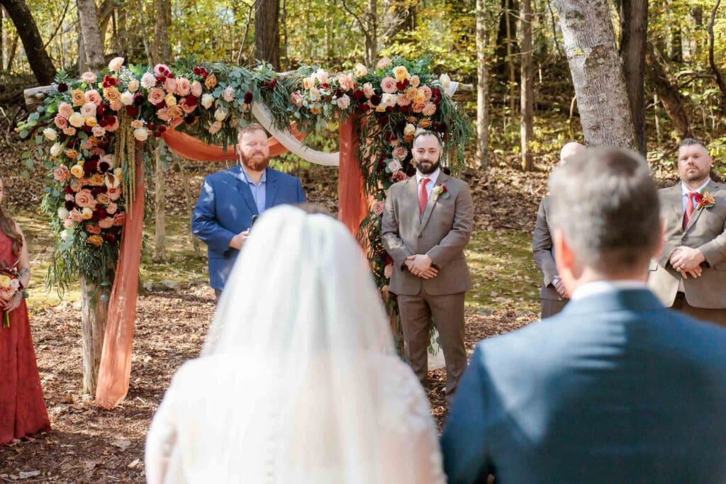 Groom watching his bride walk down the aisle
