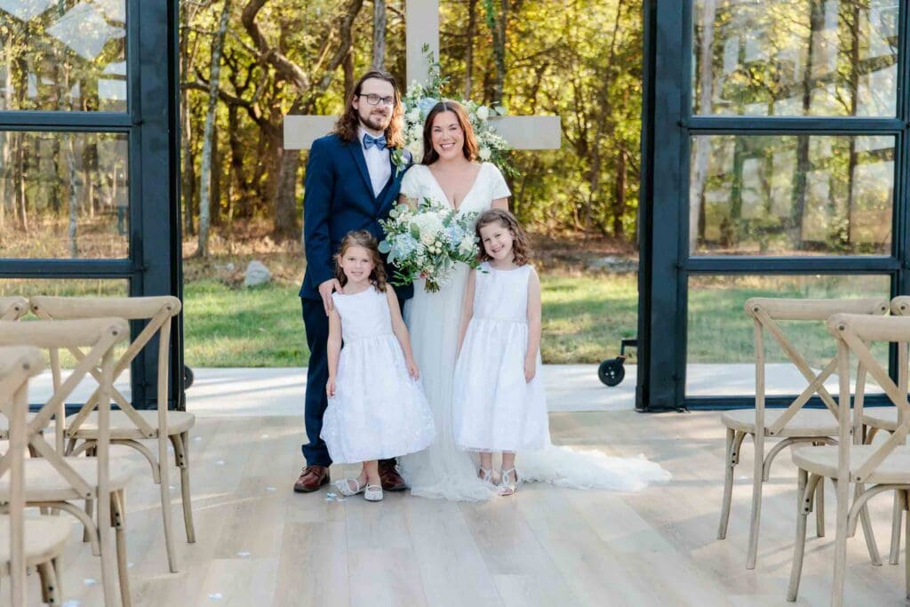 Bride and groom celebrating their marriage with their daughters at Jubilee Woods